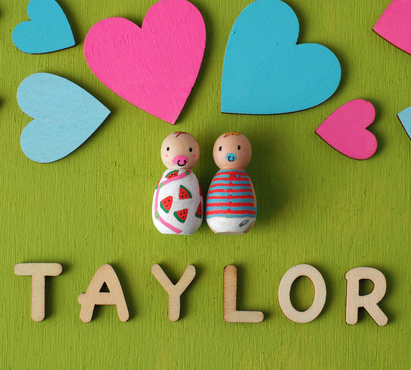 baby shower guestbook alternative - peg dolls.  Baby Shower Wooden Guest book!  Have your guests sign a heart and hang this guestbook in the baby or babies's room after the shower.  Great keepsake and nursery décor! We hand-paint the baby peg dolls. Whether you are having a baby, twins, or triplets, we can customize.
