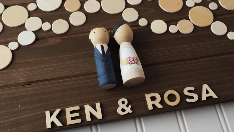 Personalized Wedding Guest book with hand-painted bride and groom peg dolls.   Have your guests sign a wooden circle, depicting lantern lights.  Hang this guestbook after the wedding to preserve beautiful memories of your special day for many years to come.  This 28"x11" wooden Wedding guest book alternative consist of up to 110 sign-able wooden circles.  It is sufficient for at least 150 guests.
