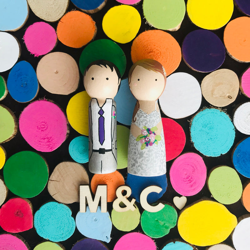 Wooden Wedding guestbook alternative and custom wedding couple on wooden peg dolls! Why pick only a few colours for your wedding theme when you can have the whole world of colours!  Customize your portraits on tiny peg dolls and have your guests sign a wooden disc.  Hang this framed guestbook after the wedding to preserve beautiful memories of the special day for many years to come.