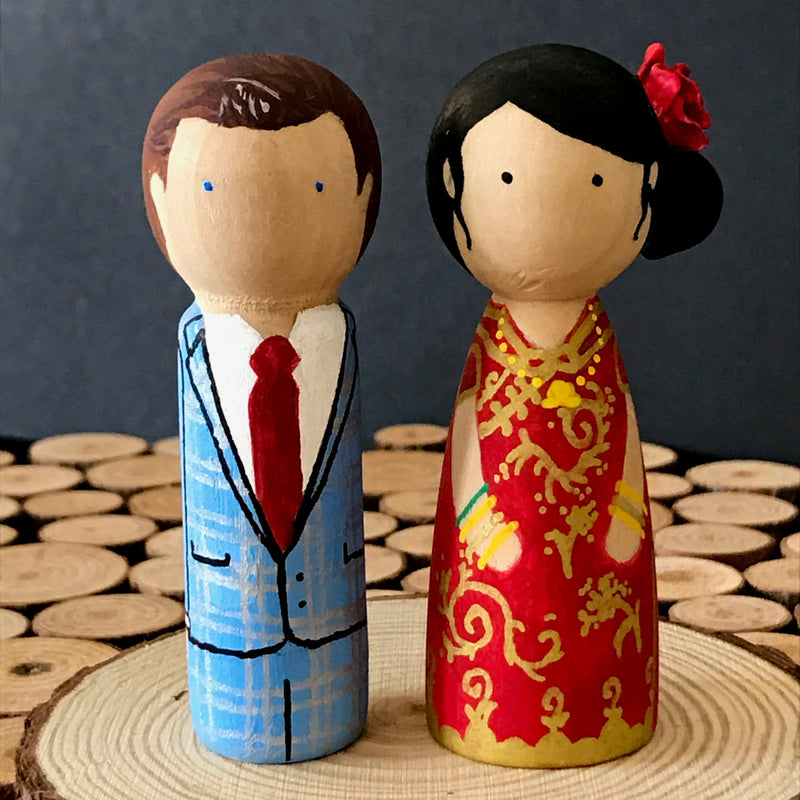 Chinese Wedding Peg Dolls.  Customized wedding cake topper!  These cute peg dolls show the unique sides of you and your partner.  A great touch of personality to your wedding.  They will WOW your guests.  Also, what a great keepsake it would be!  These are also great for anniversary gifts, couples’ gifts, bridal showers, or any other occasions.  We hand-paint the peg dolls to match your wedding attires and culture.
