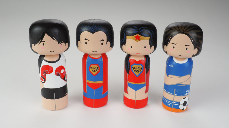 Custom super dad Kokeshi doll!  Introducing our new 2 in 1 family portrait Kokeshi dolls! 2 Designs of the same person hand-painted in 1 doll. Everyone has many roles, interests, careers, personalities, and we all wear many hats in life. Why not highlight and celebrate those in a hand-painted doll! 1 design on one side, turn the doll around and it shows another design. The toughest part is probably to choose the 2 roles you like us to paint. 